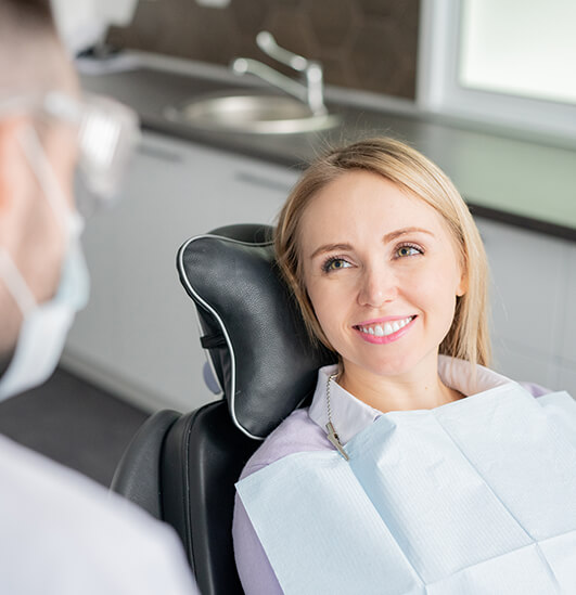 smiling woman sitting in a dental chair