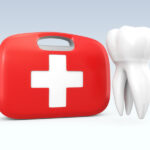 A floating tooth next to a red and white first aid kit to indicate a dental emergency