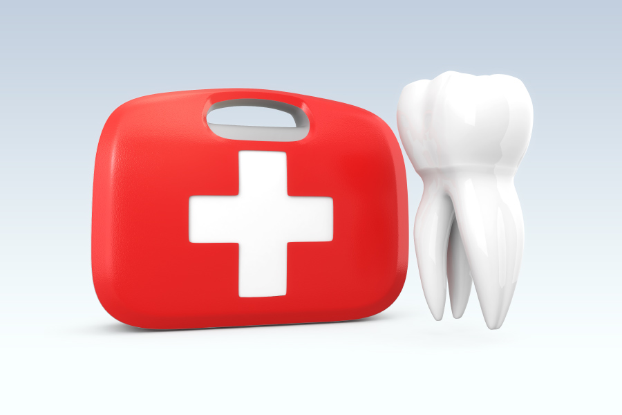 A floating tooth next to a red and white first aid kit to indicate a dental emergency