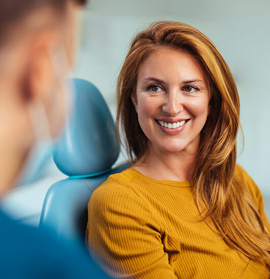 smiling woman sitting in a dental chair