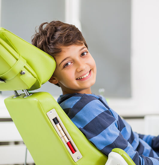 boy sitting in a dental chair